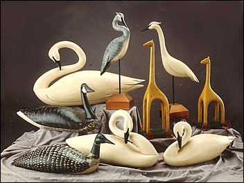 A display of wood sculptures by Rick Heller, many life size, including swans, giraffes, herons and geese.